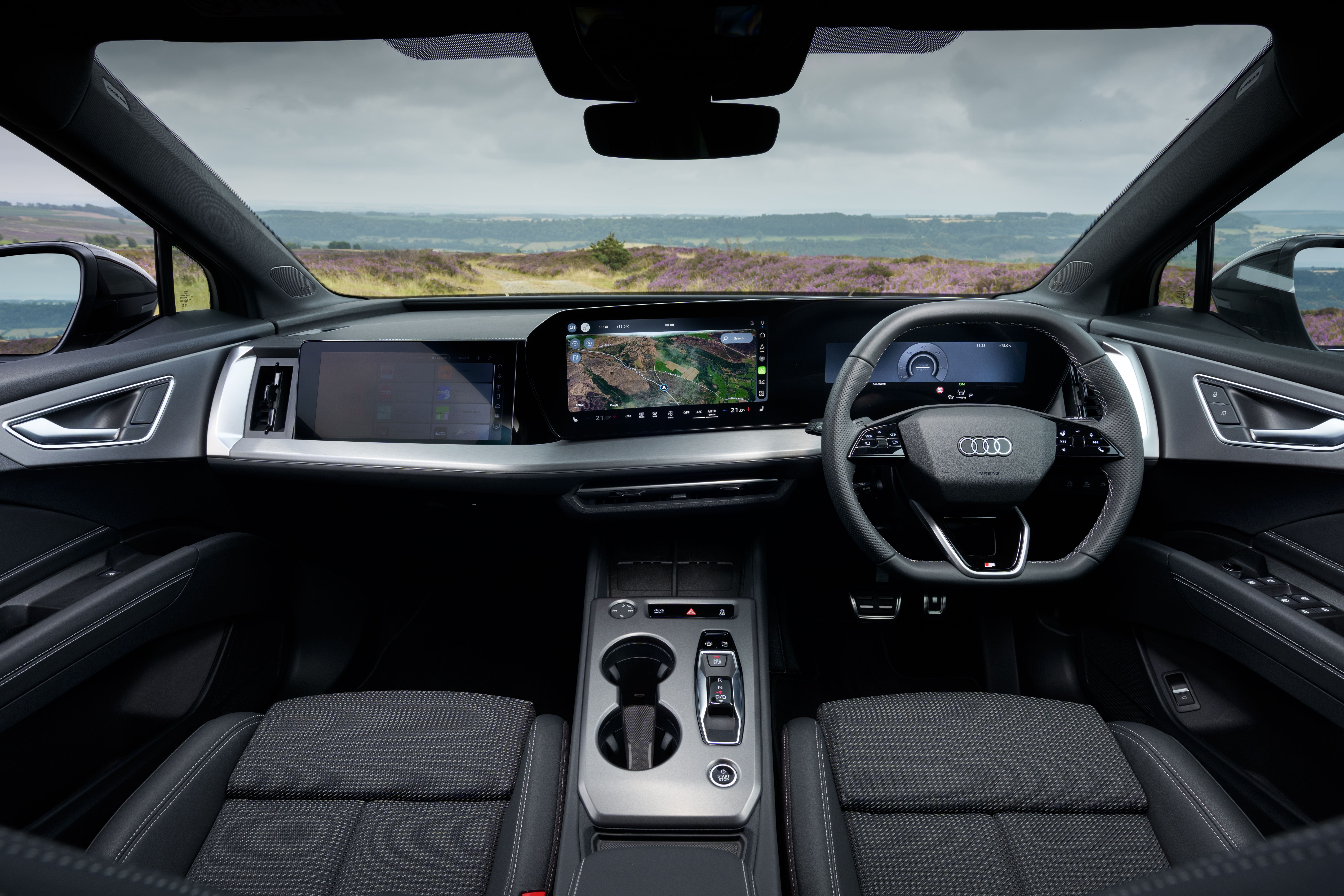 Audi Q4 e-tron interior with digital displays, navigation screen and multifunction steering wheel.
