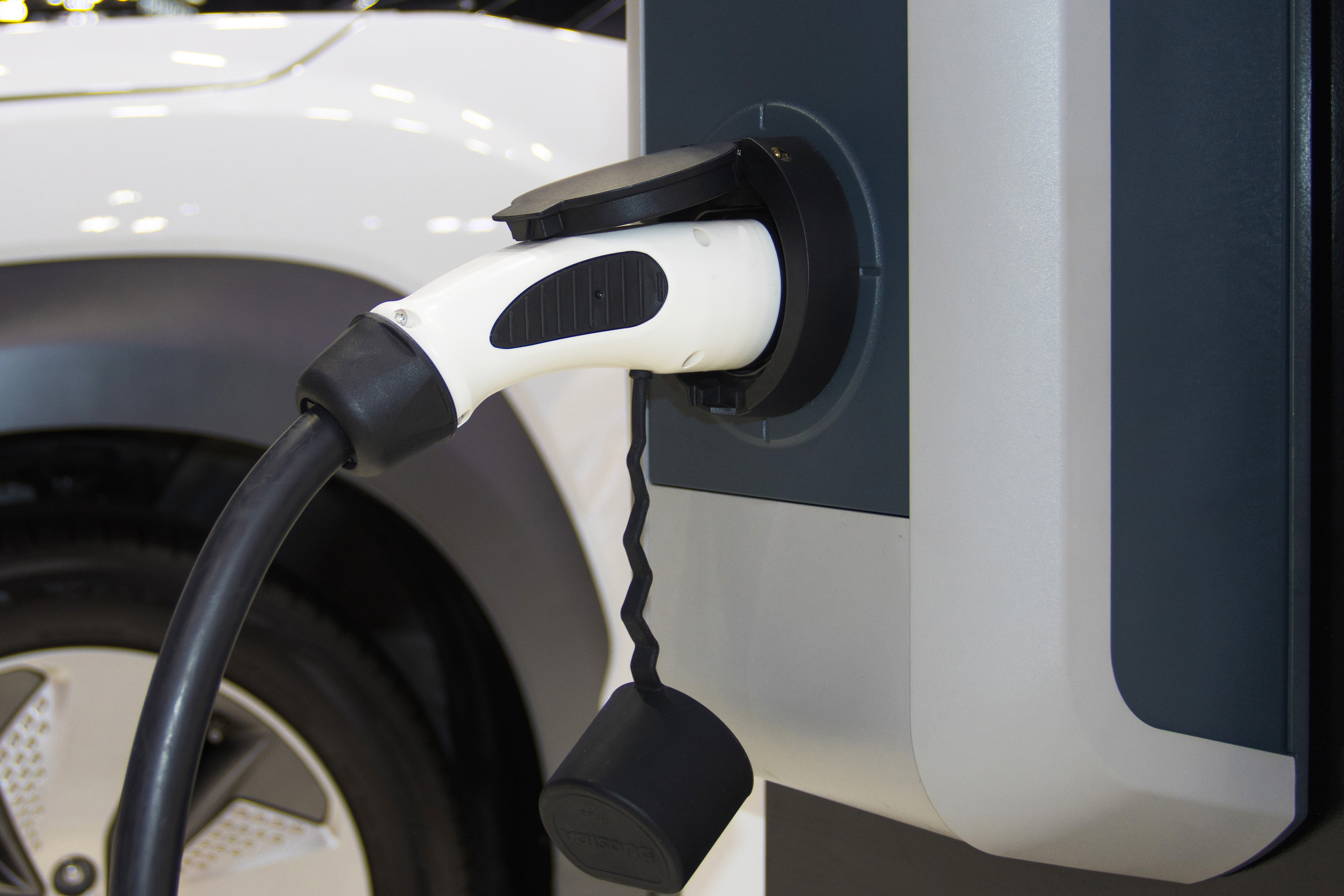 the charging the battery for the car new Automotive Innovations the power supply plugged into an electric car being charged, concept of energy innovation.