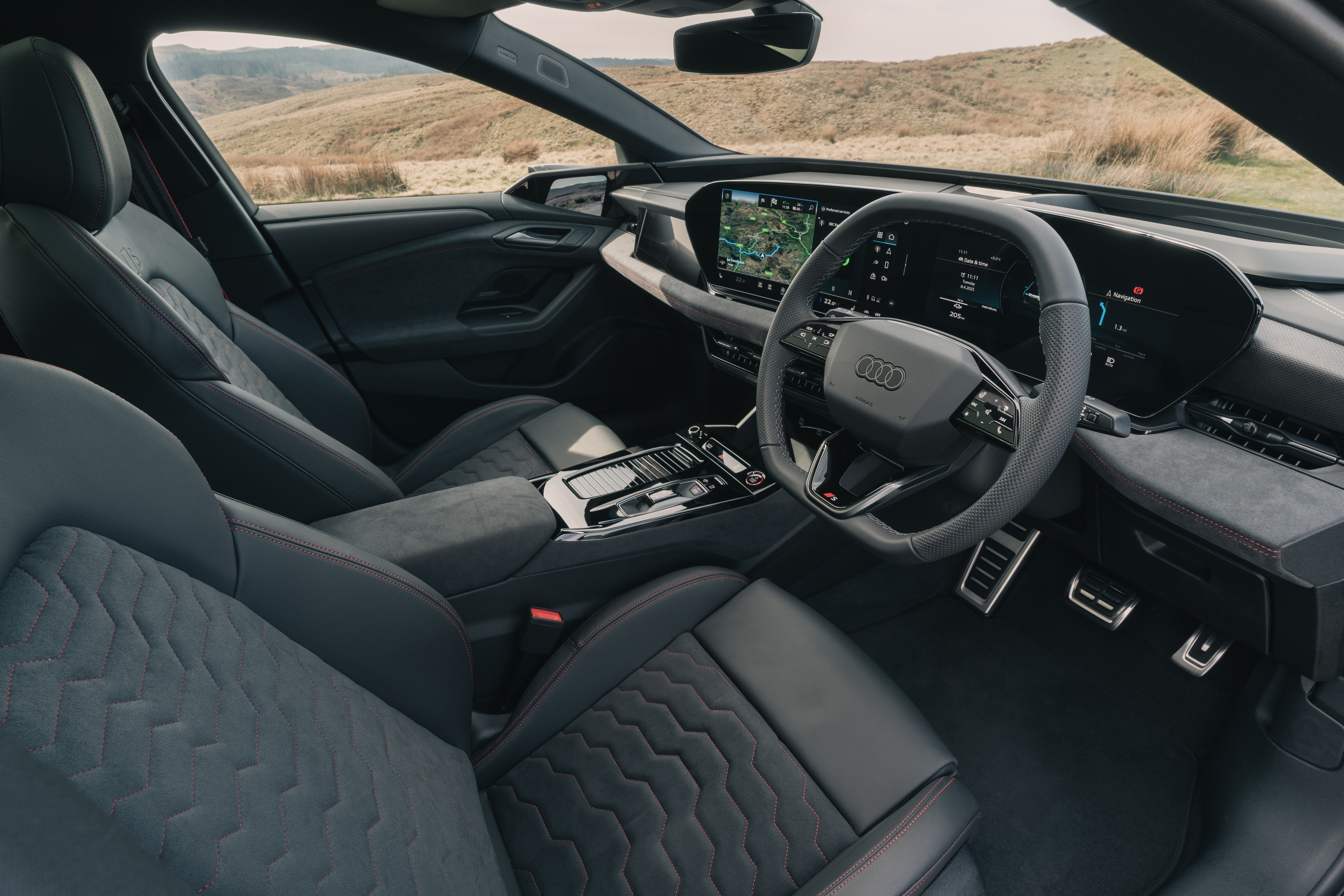 Audi Q6 e-tron interior with sports seats, digital dashboard and central touchscreen.